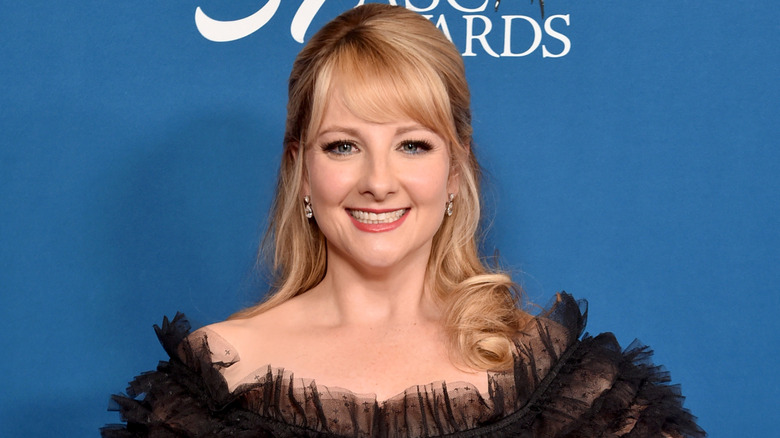 Melissa Rauch smiling on step-and-repeat