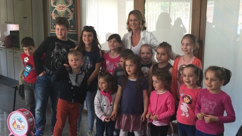 Nadia Comaneci posing with children at her Bucharest clinic