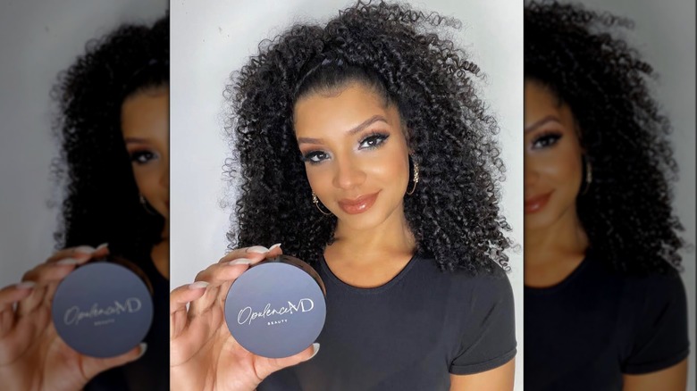 Model holding OpulenceMD lashes