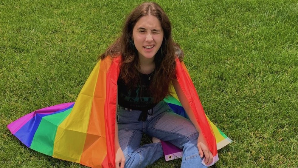 Max Dubrow draped in rainbow flag