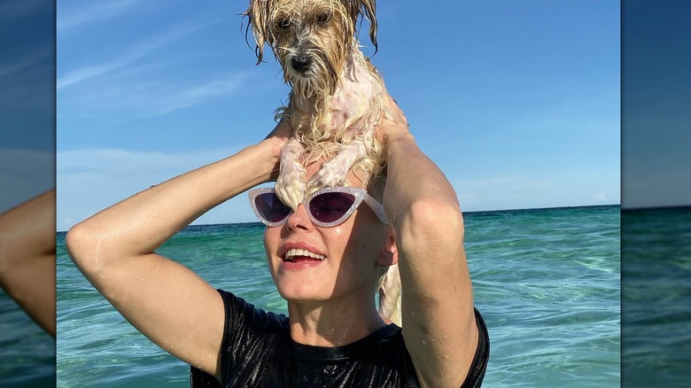 Rose McGowan swimming with dog