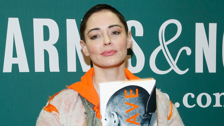 Rose McGowan holding her memoir