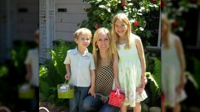 Amber posing with her two children at home.