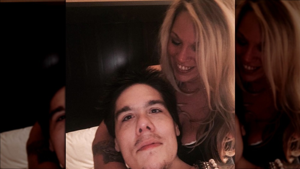 Steven Assanti poses in bed with his wife