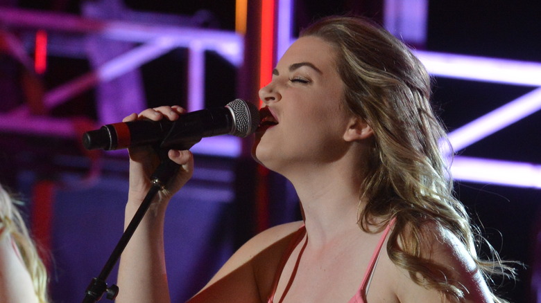 Britt McKillip singing into a microphone