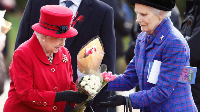 Queen Elizabeth II and Mary Morrison exchanging flowers