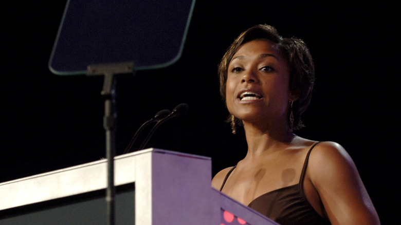 Dominique Dawes speaking at a podium 