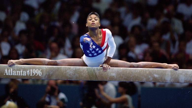 Dominique Dawes on a balance beam in 1996 