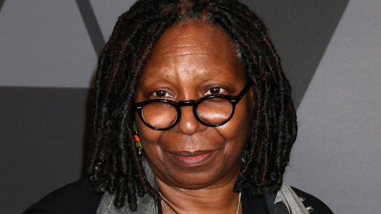 Whoopi Goldberg wearing black glasses