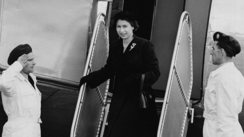 Queen Elizabeth debarking airplane