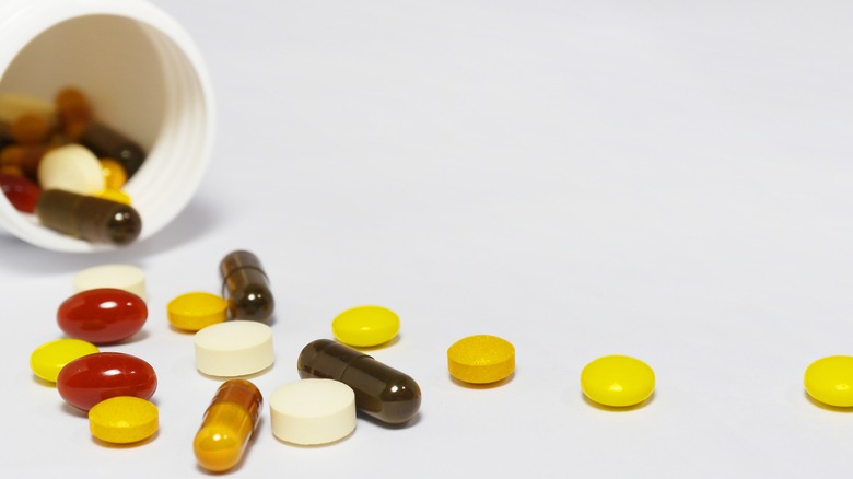 An assortment of supplements from a white bottle