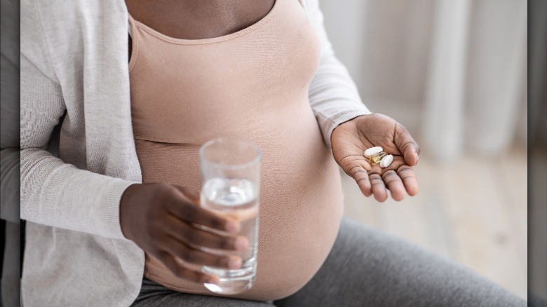 Pregnant woman taking supplements