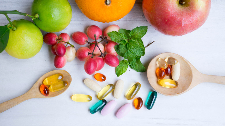 Supplements on spoons with fruits