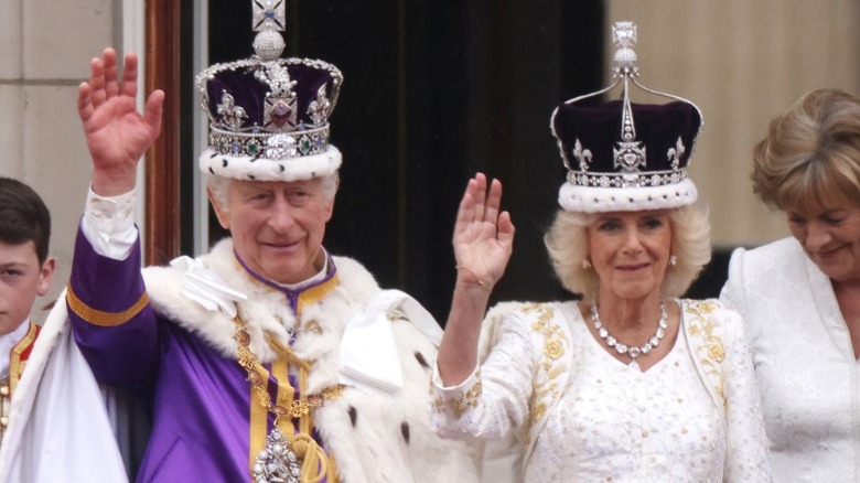 King Charles and Queen Camilla waving