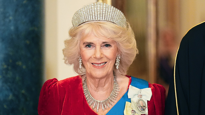 Queen Camilla smiling and wearing a tiara