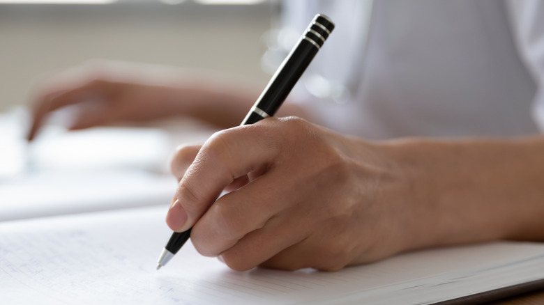 Woman writing in a notebook