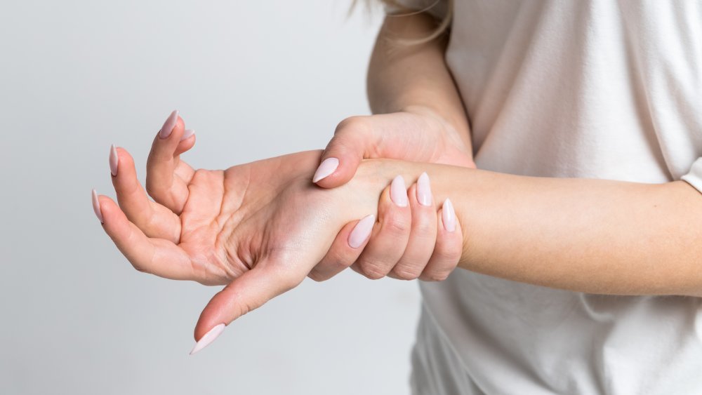 A woman holding onto her wrist