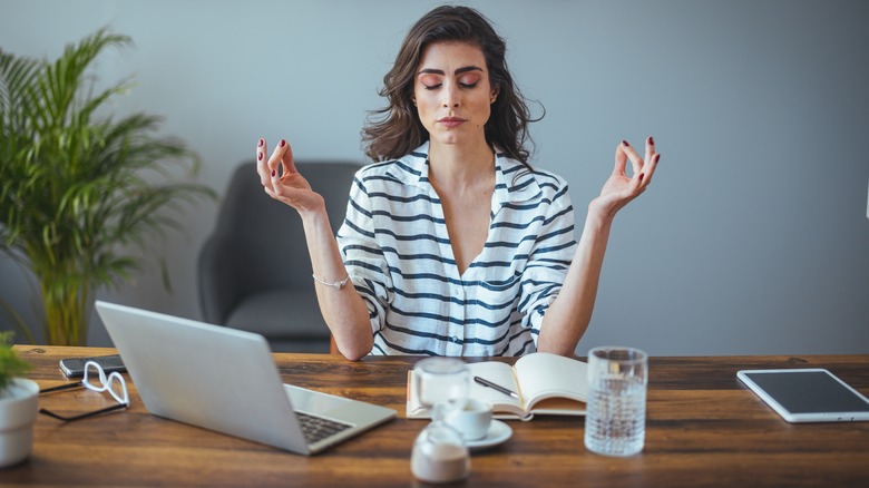 woman meditating at work