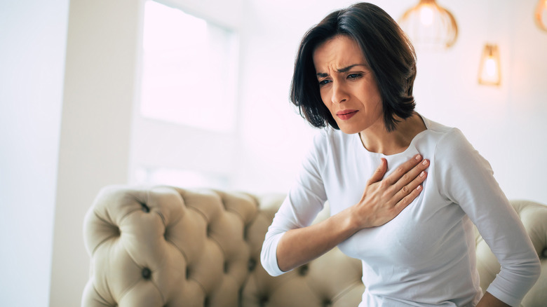 woman touching heart in pain