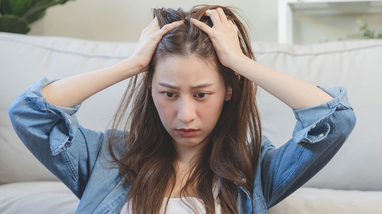 confused woman holding hair