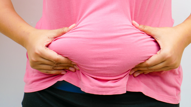 Woman squeezing belly