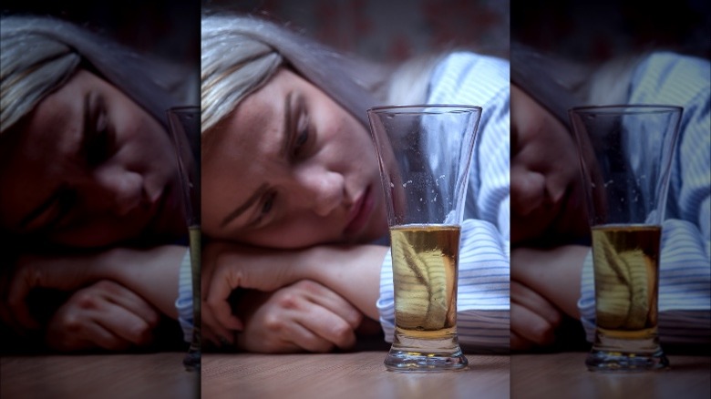 Woman looking at beer glass