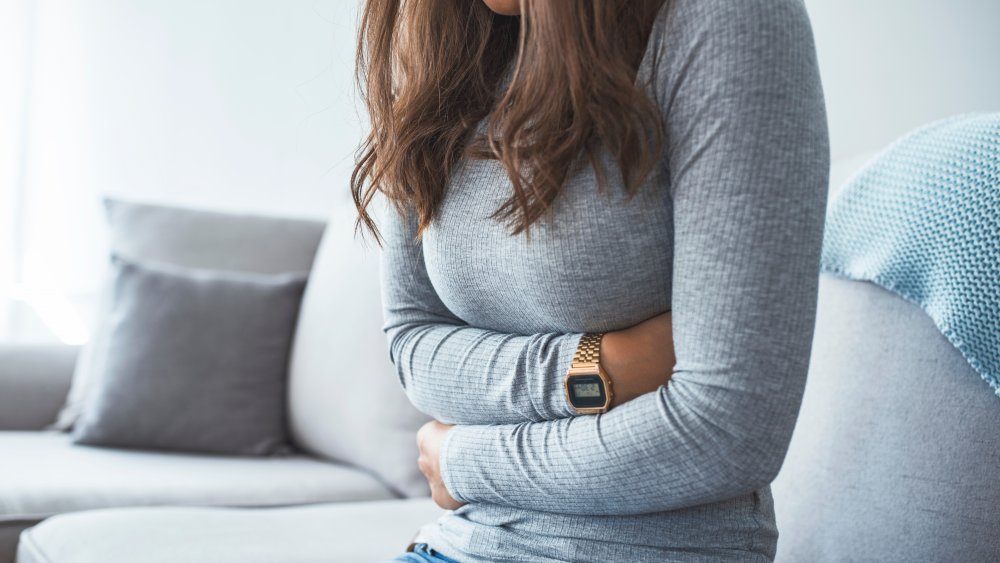 woman holding stomach