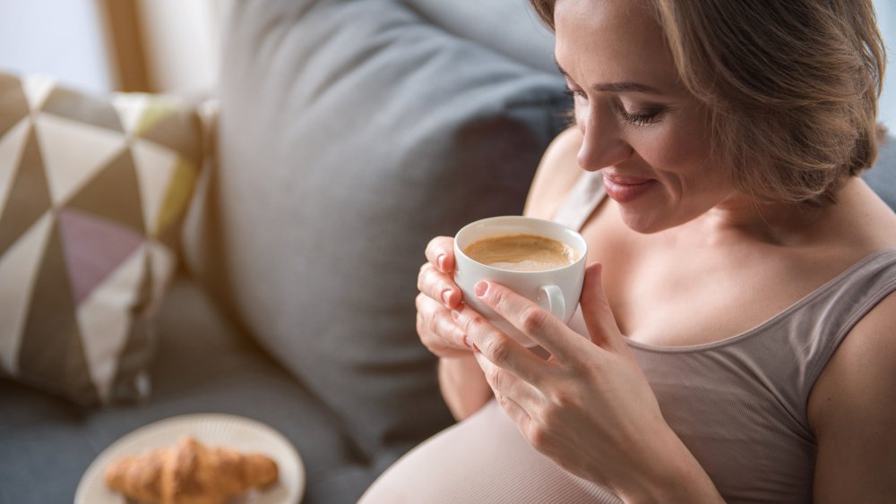 pregnant woman drinking espresso