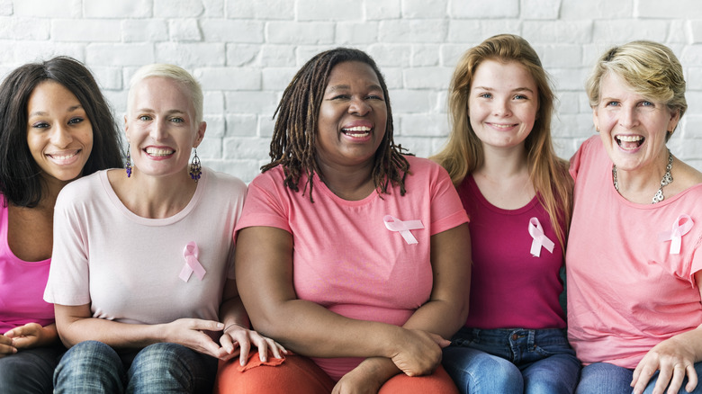 A group of women wearing pink shirts