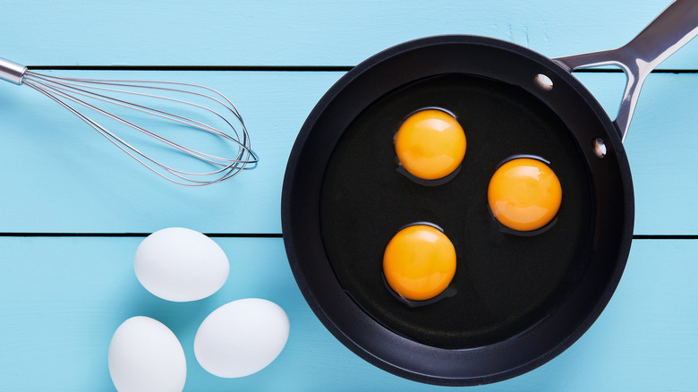 eggs in skillet with whisk