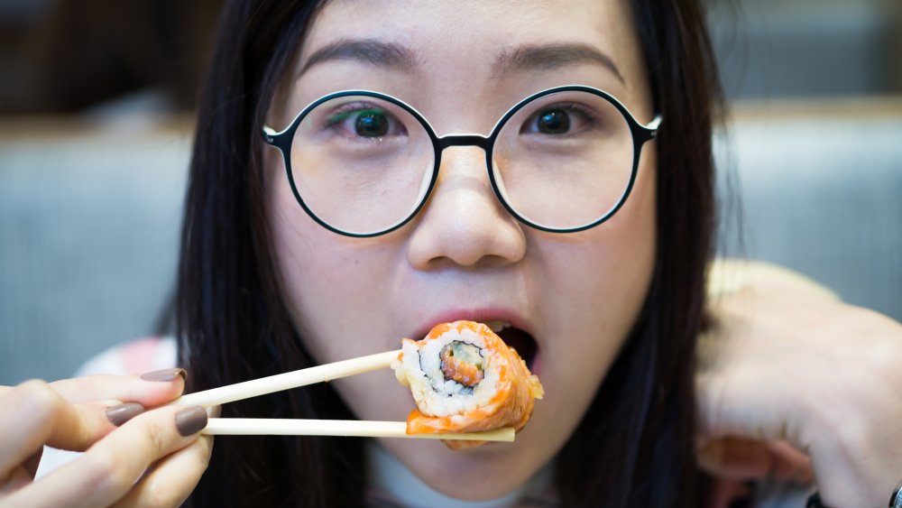 woman eating sushi