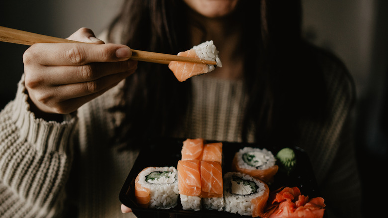 woman eating salmon sushi