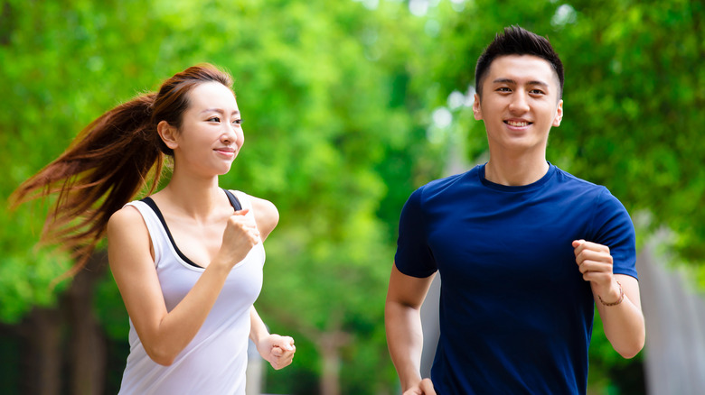 A couple jogging outdoors