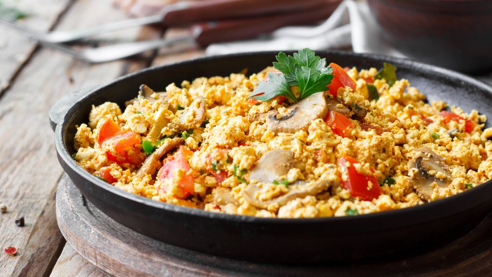 Tofu scramble in a skillet with mushrooms and bell peppers