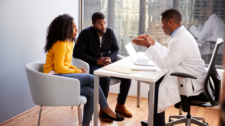 A couple talking to their doctor