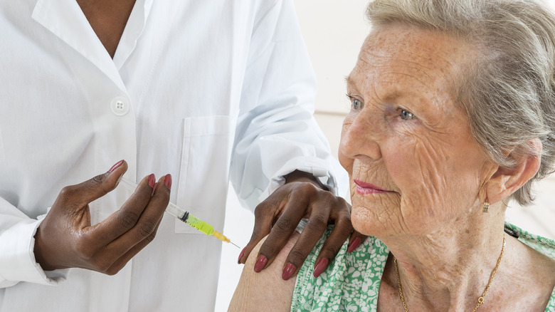 A senior women receiving a flu shot