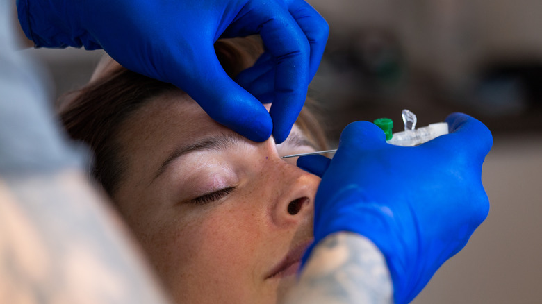 a woman getting pierced