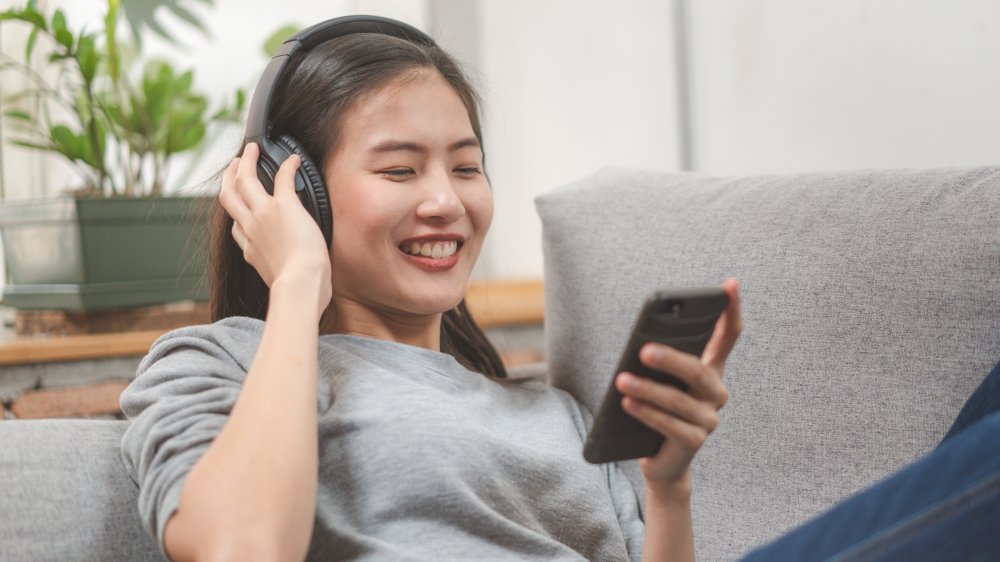 A relaxed woman on the couch listening to music