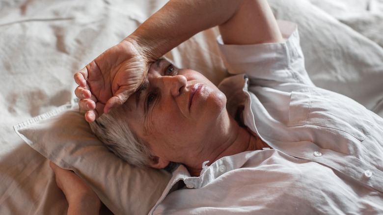 concerned woman on bed