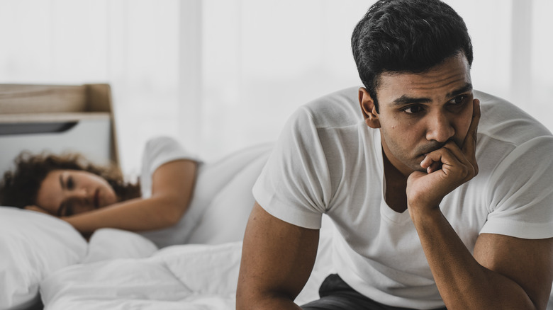 distressed couple in bed