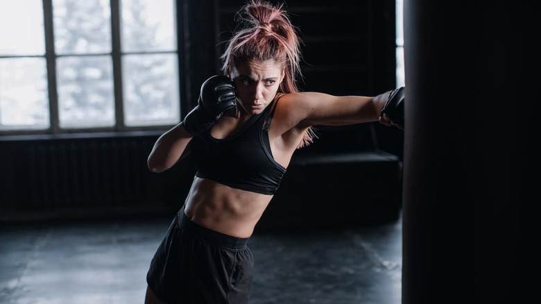 A woman punching a bag