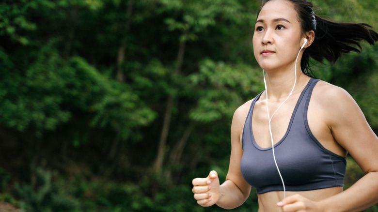 A woman running with headphones in