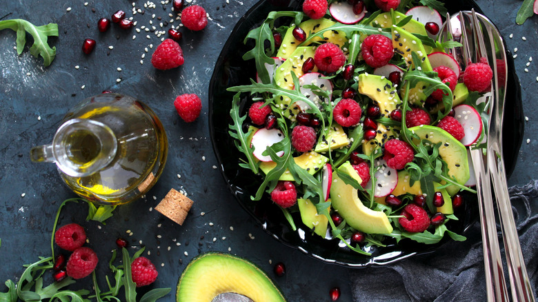 A salad with avocado and berries