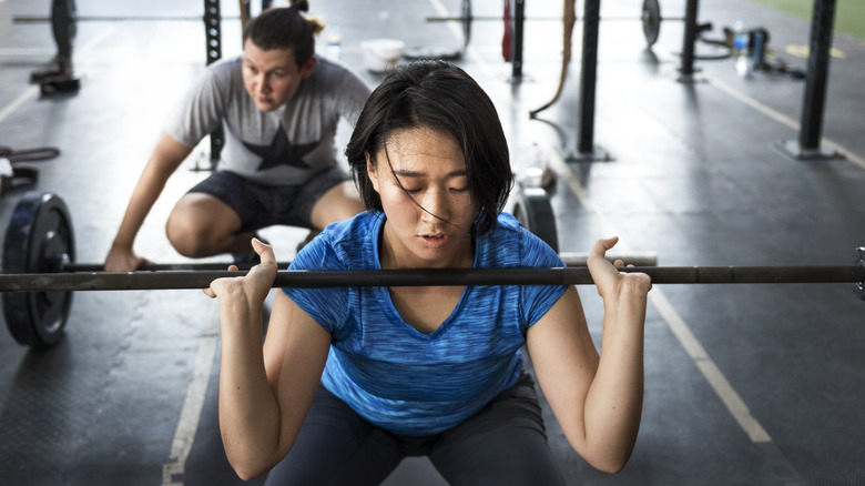 A woman lifting weights at the gym