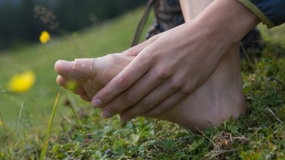 woman looking at bandaged foot