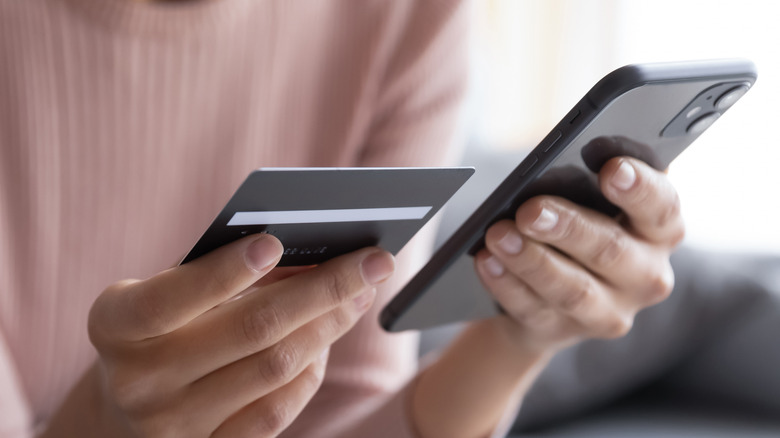 Woman makes purchase on phone