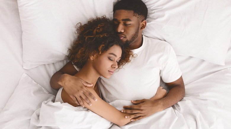 Young couple happily asleep