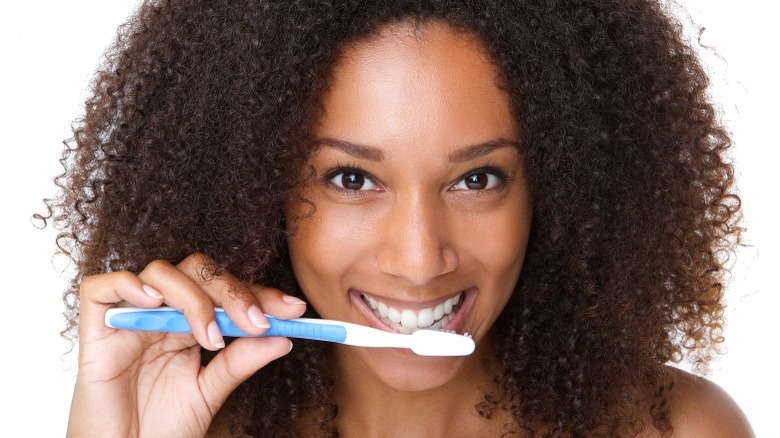 woman brushing teeth 