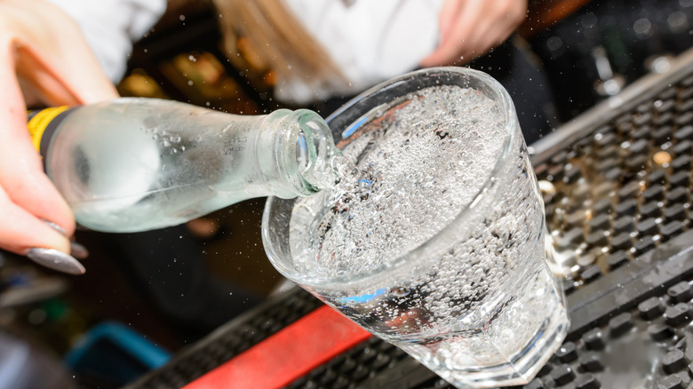 Seltzer water being poured into a glass