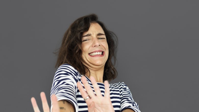 frightened disgusted woman with hands up